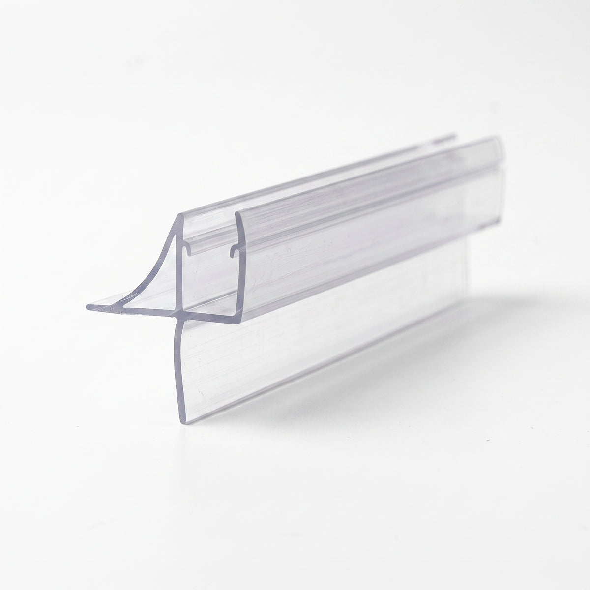 Clear shower seal offcut on white, glass channel with a curved flick fin and a straight blade below
