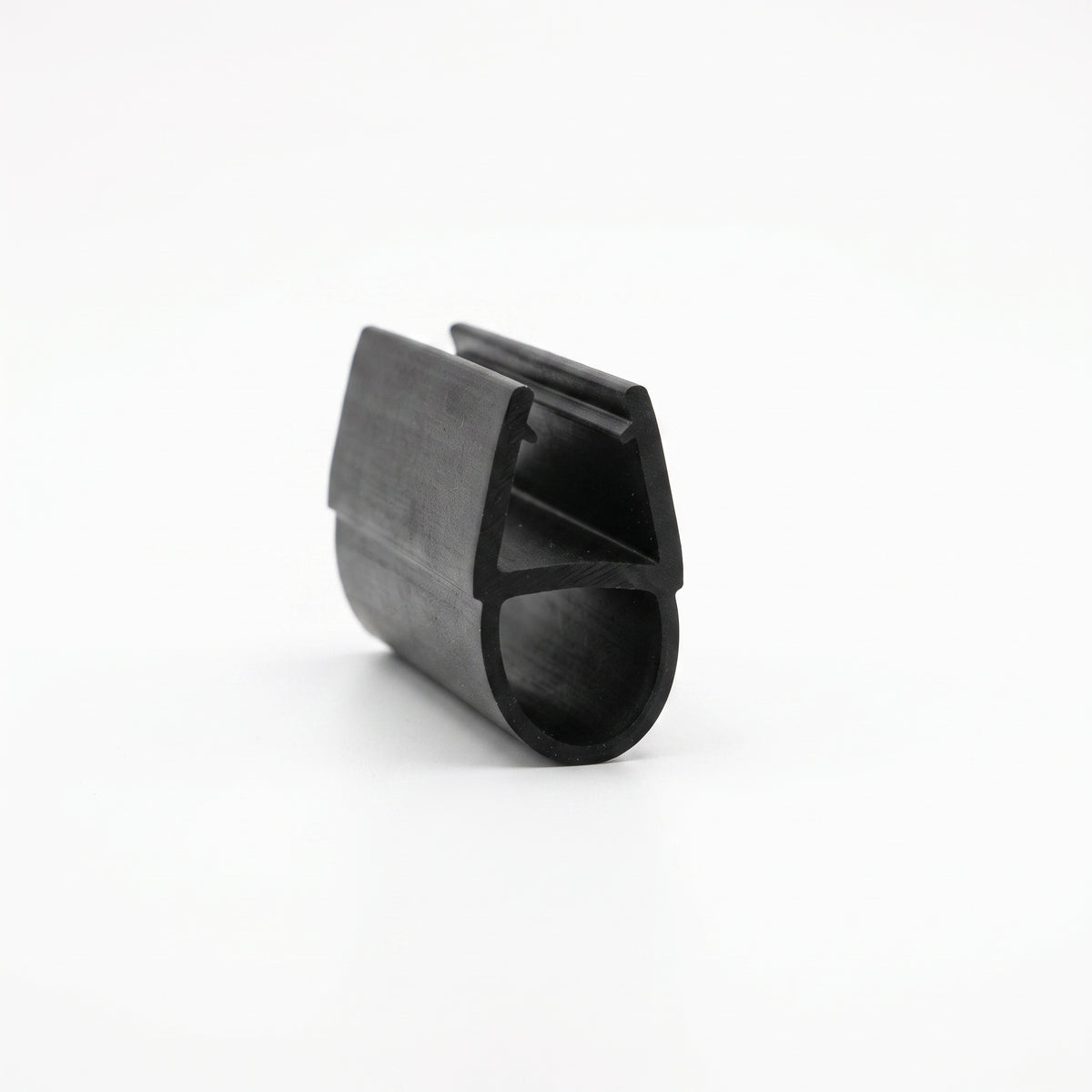 Black rubber seal offcut on white, glass channel above a rounded hollow bulb