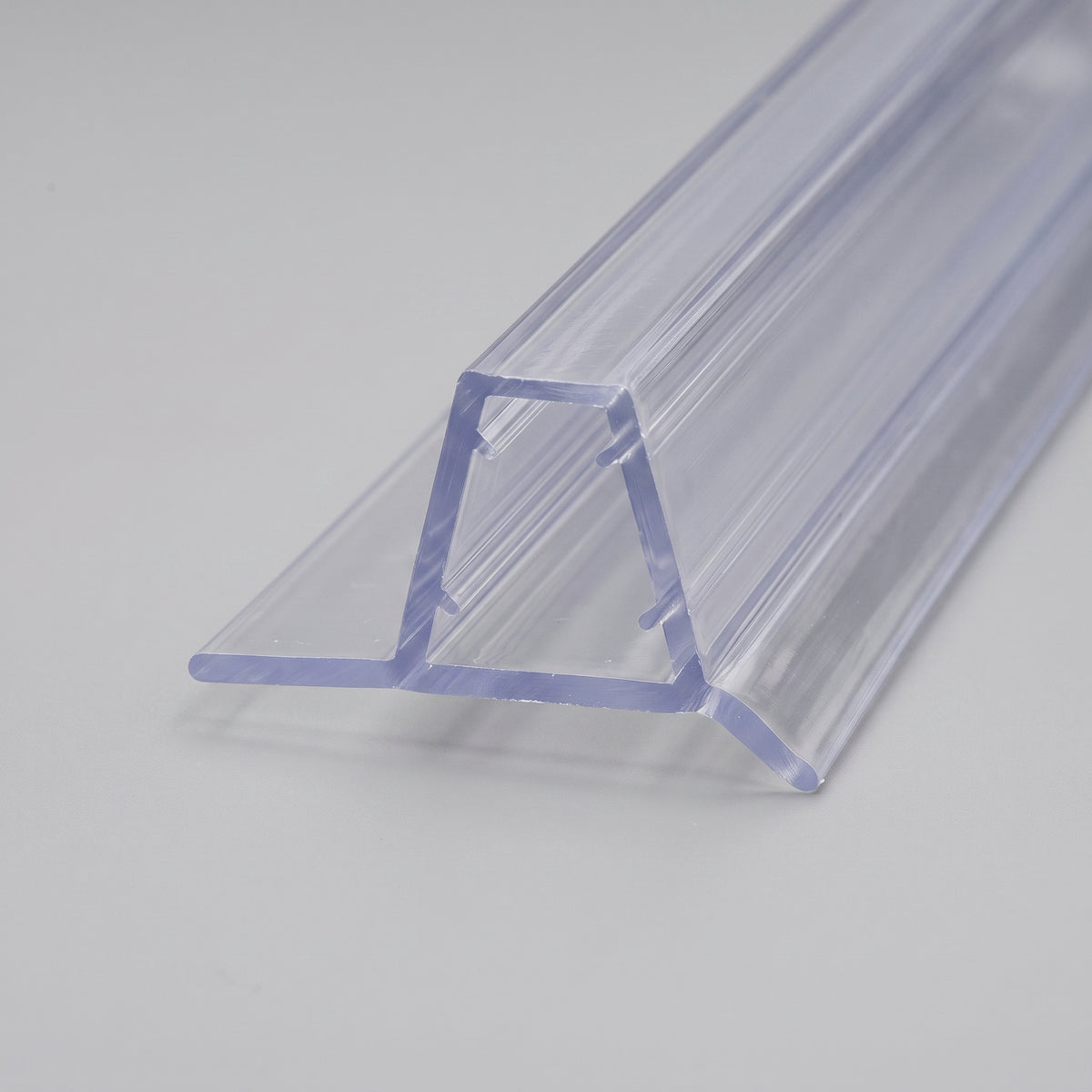 Clear seal length angled on white, glass channel with a wide flat base flap and an angled drip fin
