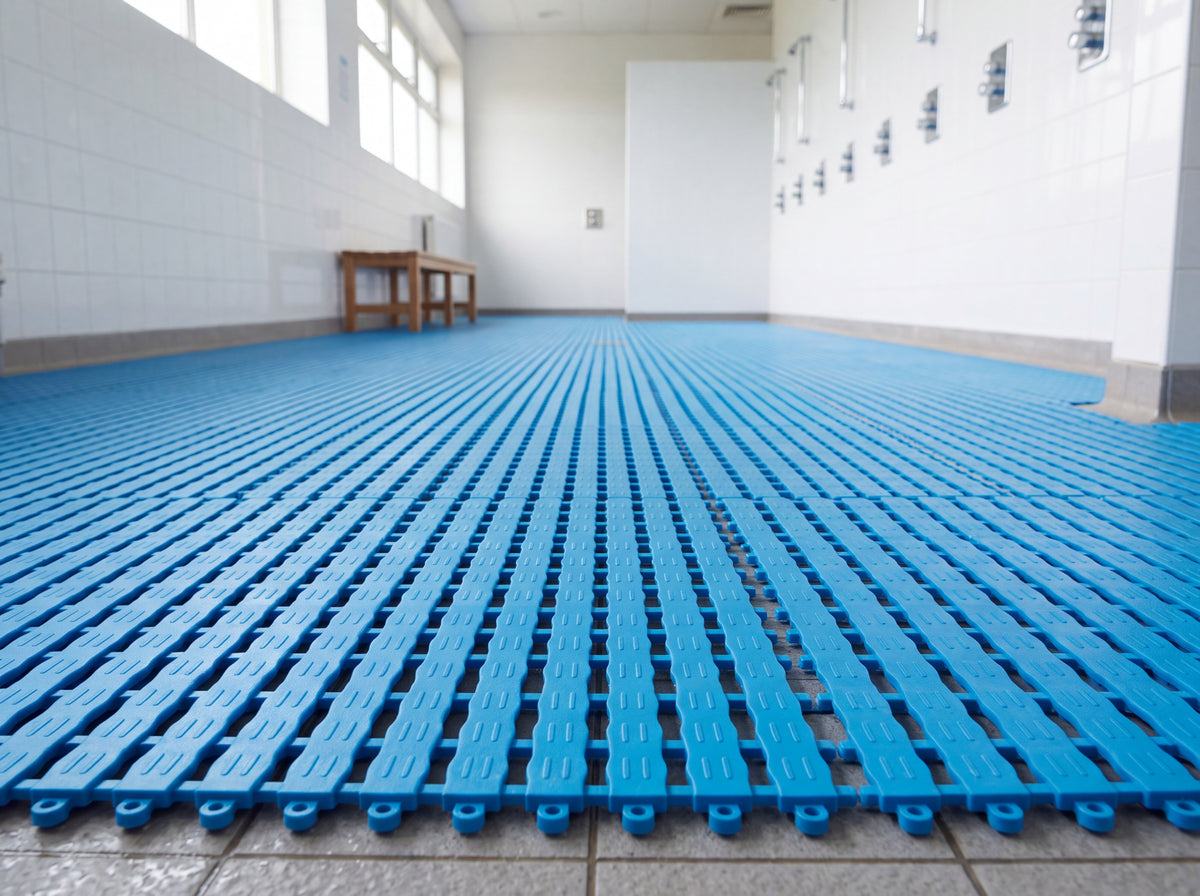 Ocean blue interlocking EVA barefoot tiles covering a communal shower and changing room floor