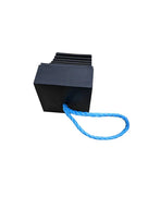 Rear view of black rubber wheel chock showing flat back face and ridged top edge, blue rope