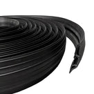 Coiled black rubber cable cover with its cut end showing the internal cable channel