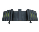 Black rubber ramp face-on, three lime green strips per ribbed wing, raised centre block and two round pegs