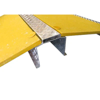 Close-up of the chequer-plate centre spine and the galvanised triangular tunnel beneath the yellow wings