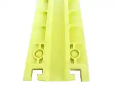 Cropped end view of the yellow protector, showing the two circular cable bores through the extrusion