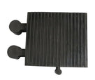 Overhead view of the ribbed black rubber block showing the two side pegs and a third peg on the front edge