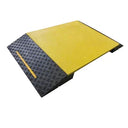 Three-quarter view of the ramp, yellow deck panel meeting the ribbed black chequer-tread approach slope
