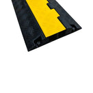 Close-up of the cover's end, yellow textured lid seated over the two channels in the black rubber body