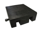 Angled view of the black rubber block section, finely ribbed top and two square notches cut in the side