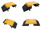 Four angled studio views of the yellow-topped hose ramp, black chequer-tread base and round tab connectors