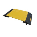 Angled overhead view of the full ramp, yellow deck flanked by both black tread slopes and round tab connectors
