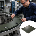 Engineer bolting a dark green curved wear plate onto a conveyor turn, inset of a green slab