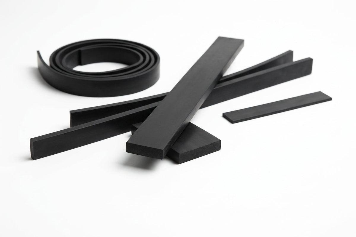 Black rectangular rubber strip cut into lengths, one coiled, on white background