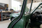 Black rectangular rubber strip fitted along a green classic car's door edge