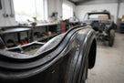 Rectangular rubber strip fitted along a riveted black classic car body trim