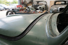 Rectangular rubber strip fitted along a green classic car's roof edge trim
