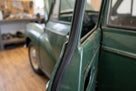 Rectangular rubber strip fitted along a green classic car's door edge