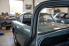 Rectangular rubber strip fitted around a blue classic car's window frame