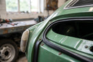 Rectangular rubber strip fitted along a green classic car's rear window seal edge