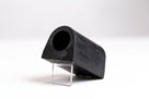 Black rubber anti-roll bar bush on a clear stand, angled studio view