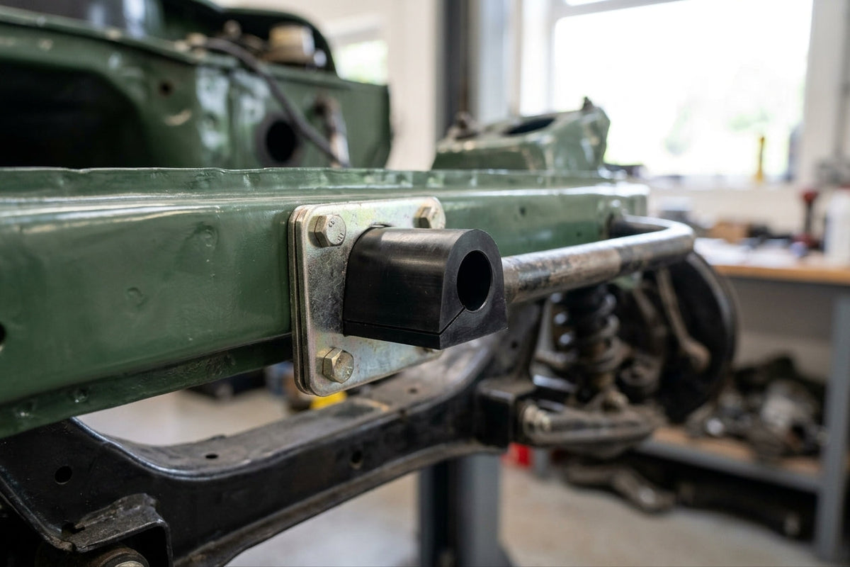 Anti-roll bar bush mounted to a green chassis rail with a metal bracket