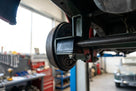 Anti-roll bar bush fitted near a wheel hub on a vehicle up on a ramp