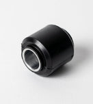 Black rubber link bush with metal sleeve, angled studio shot
