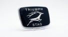 Black and chrome TRIUMPH STAG grille badge with leaping stag, studio shot on stand