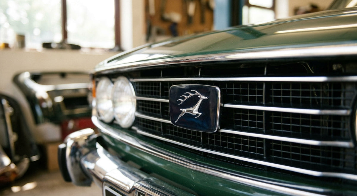 Chrome-edged stag grille badge fitted to a green Triumph Stag Mk2 front grille