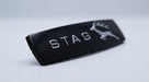 Black gloss STAG side badge with stag emblem on the right, angled studio shot