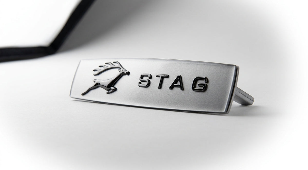 Silver STAG side badge with leaping stag on the left, angled studio shot