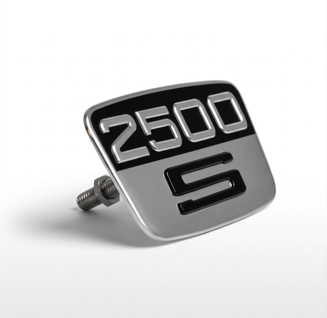 Silver and black 2500 S badge with rear fixing bolt, angled studio shot