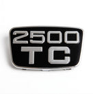Chrome-framed black badge reading 2500 TC, front-on studio shot