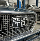 2500 TC badge fitted in the mesh grille of a dark blue classic car