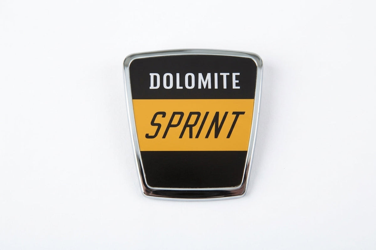 Shield-shaped chrome DOLOMITE SPRINT badge, studio white background