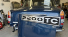 2200TC badge fitted to the boot lid of a blue classic car in a garage