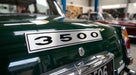 3500 badge fitted to the boot lid of a green classic Rover in a workshop