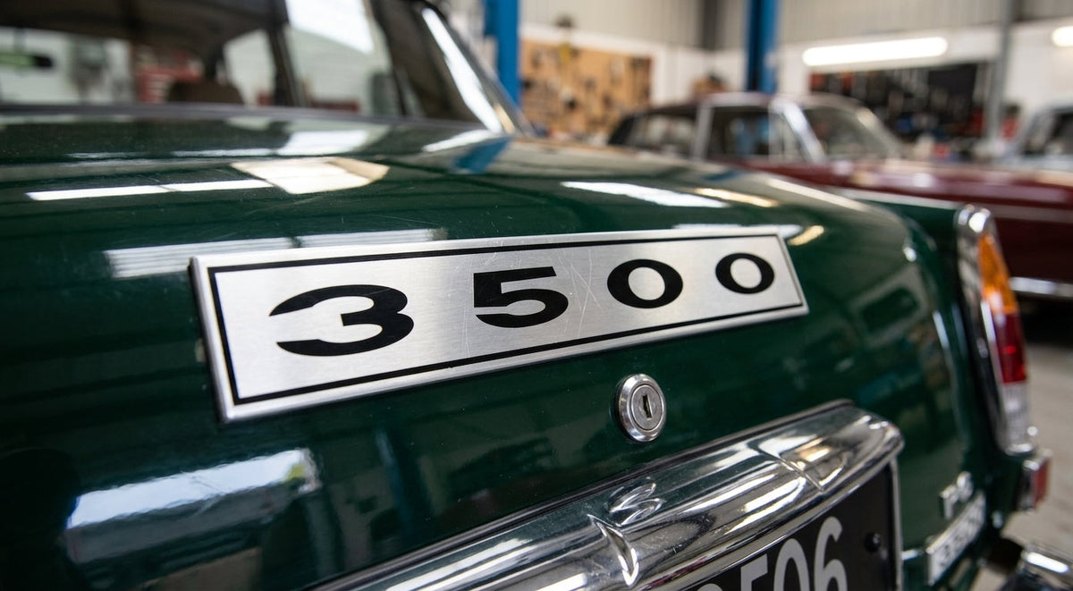 3500 badge fitted to the boot lid of a green classic Rover in a workshop