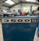3500S badge fitted to the wing of a blue classic car in a workshop