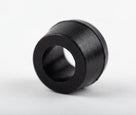 Black cylindrical polyurethane bush with central bore, angled studio shot