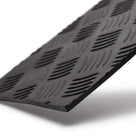 Black rubber chequer plate matting, angled close-up studio shot