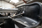 Black rubber panel lining an engine bay wing in a classic car restoration