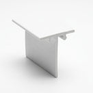 White PVC T-shaped edge trim standing upright, glossy finish, viewed at an angle