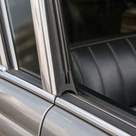 Black seal fitted to a chrome-trimmed window frame on a classic car interior