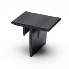 Black T-shaped corner section piece standing upright on white background