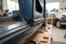Black self-grip rubber seal fitted along a door edge of a classic car being restored