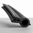 Self grip top seal resting at an angle showing a large round hollow sponge bulb above the metal grip