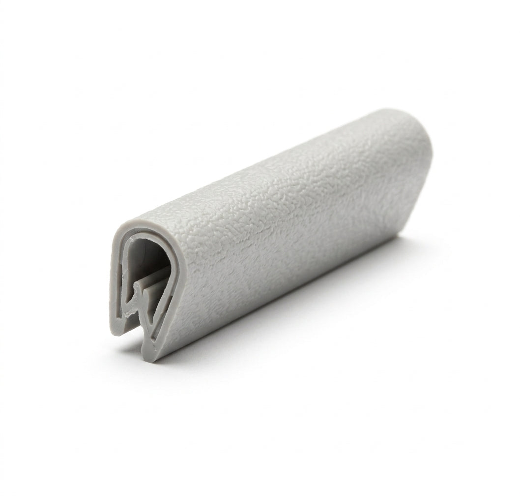Short block of grey textured PVC edging strip shown end-on with a teardrop grip profile