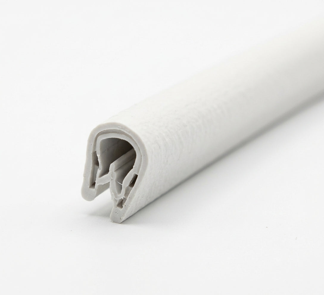 Cut length of white textured PVC edging strip shown end-on with the metal insert visible
