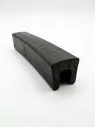 Black EPDM U-channel profile length, plain studio photo showing square-ended groove